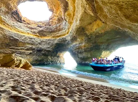 Boat cruising in search of dolphins on the Benagil Caves dolphin watching tour